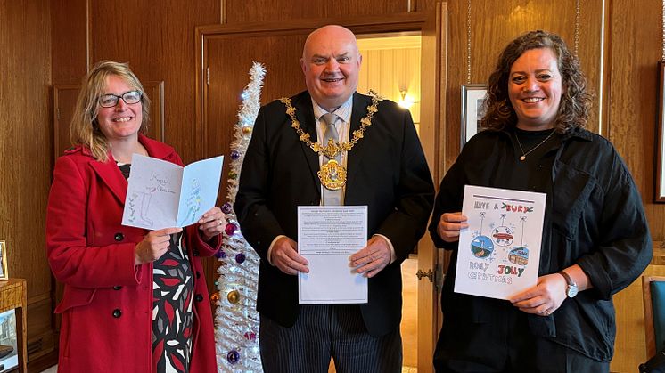 The Mayor, Cllr Noel Bayley, launches the Christmas card competition, flanked by Cllr Lucy Smith (cabinet member for children