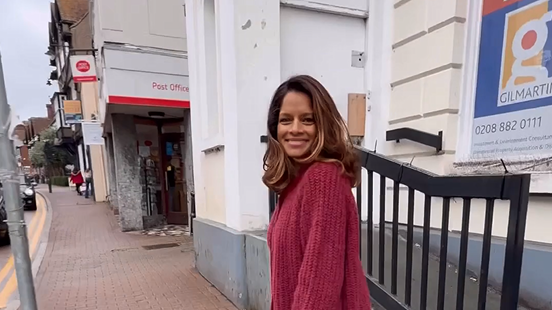 Dilly Carter smiles outside a Post Office branch as she heads inside