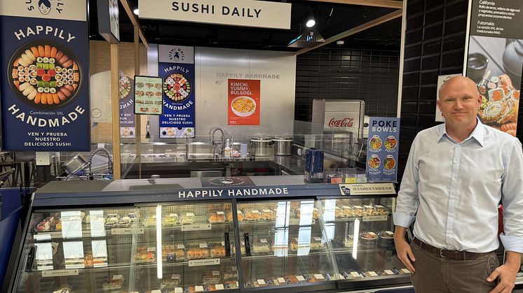 Bildet viser Tore Holvik som står foran et sushi-utsalg i Spania